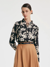 a lady in black long sleeve silk blouse